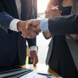 men in suits shake hands - deal or no-deal article