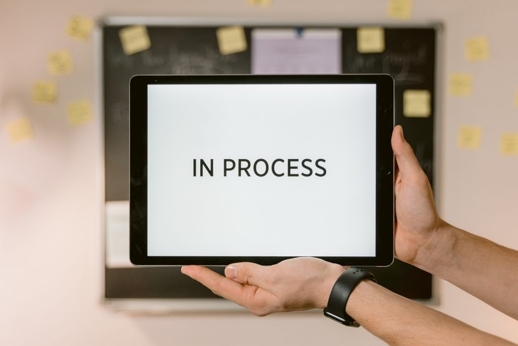 a screen displaying the words 'in process'